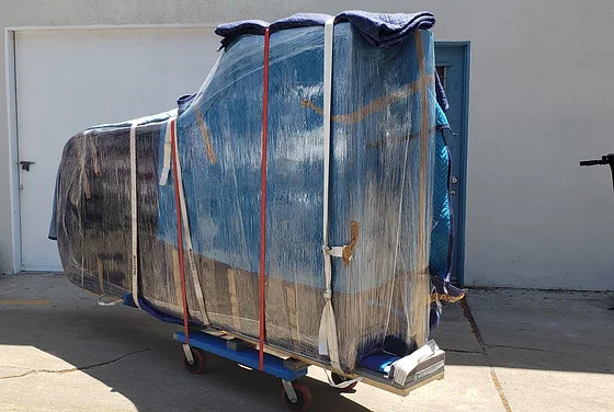 Movers delivering and placing a piano in a home